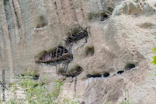 Old wooden ladders cling to the side of an eroded cliff face  in Meteora  Greece