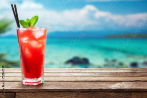 Abstract light bokeh at Summer holiday concept. Blurred image cocktail on wood with beach background.