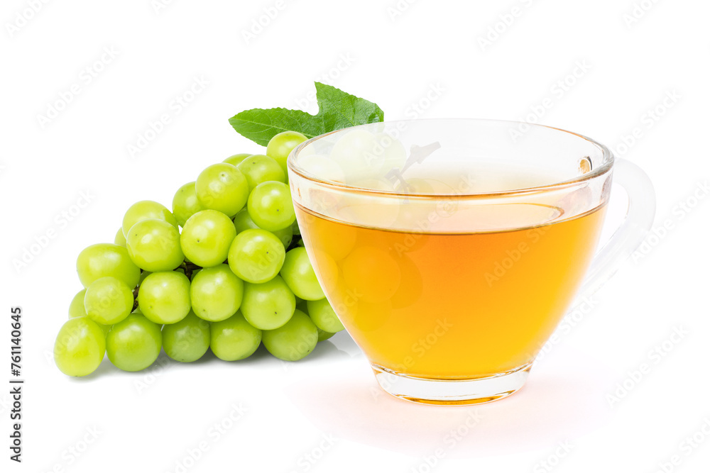 Green grape and cup of herbal tea isolated on white background. Green grape and cup of herbal tea isolated on white background.