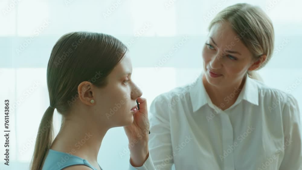 Makeup artist work in her beauty studio. Portrait of Woman applying by professional make up master. Makeup artist work in her beauty studio. Portrait of Woman applying by professional make up master.