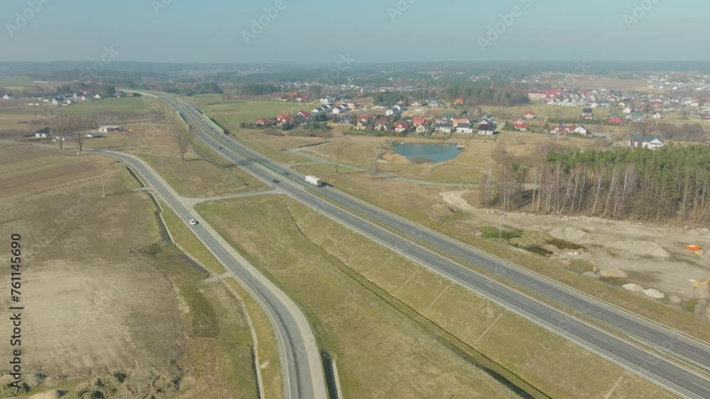 Aerial view of a highway through a rural area with houses. Aerial view of a highway through a rural area with houses.