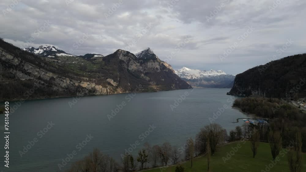 Aerial slow pan above lake shoreline in Walensee Switzerland Aerial slow pan above lake shoreline in Walensee Switzerland