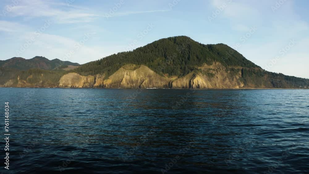 Rugged cliff, mountain peak on Oregon coast, view from Pacific Ocean. Rugged cliff, mountain peak on Oregon coast, view from Pacific Ocean.