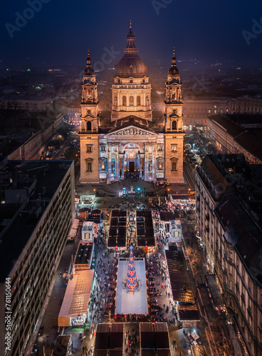 Budapest, Hungary - Aerial view of Europe's most beautiful Christmas market at the illuminated St.Stephen's Basilica. Ice rink, Christmas tree and clear blue sky at dusk photo