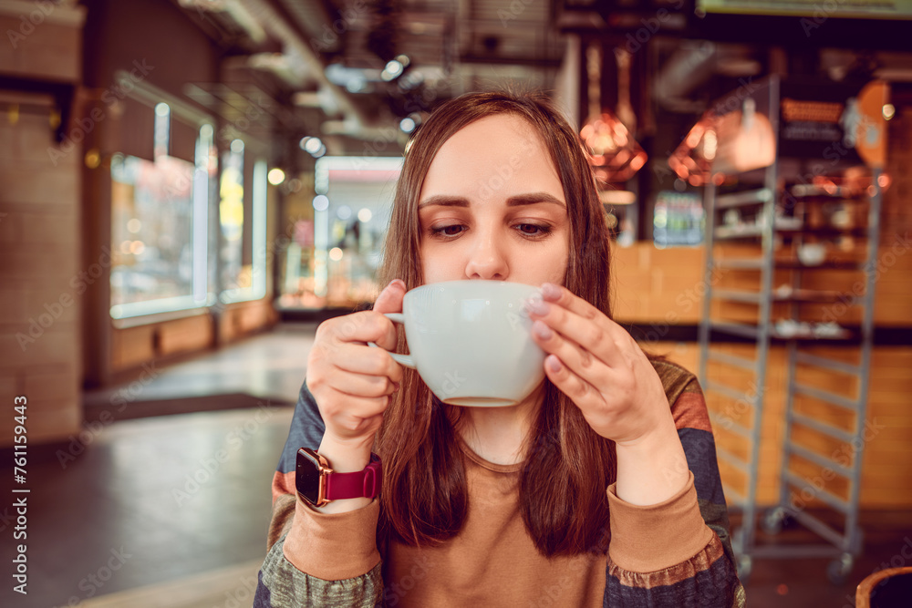 Serene Morning Moment as a Young Woman Sips Coffee in a Cozy Urban coffee shop Serene Morning Moment as a Young Woman Sips Coffee in a Cozy Urban coffee shop
