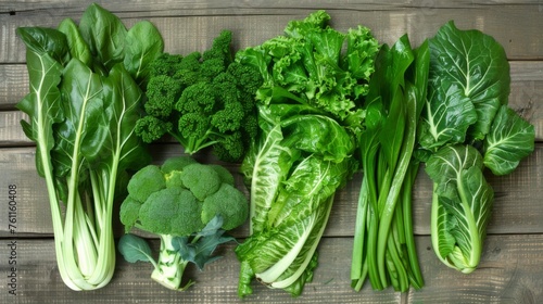 Assortment of fresh green vegetables on a wooden background. Eco-friendly healthy food. Nourishing and environmentally conscious fare for a healthy lifestyle.