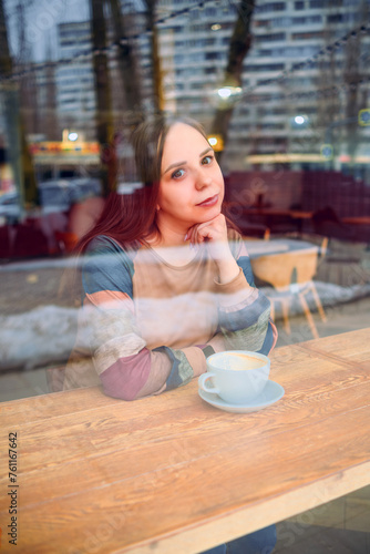 Woman Sitting at Table With Coffee