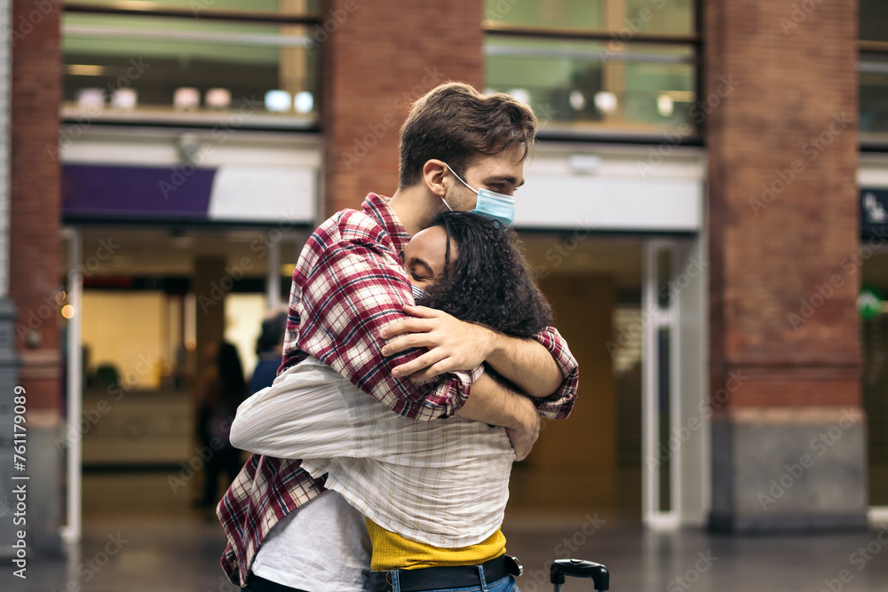 Reunited at last!: Young couple meeting at the station after a trip