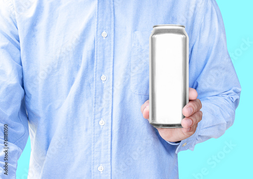 Man wear blue shirt hand hold mockup shiny aluminum can isolated on Blue background