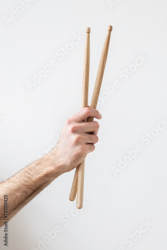 drumsticks in a man's hand on a white background