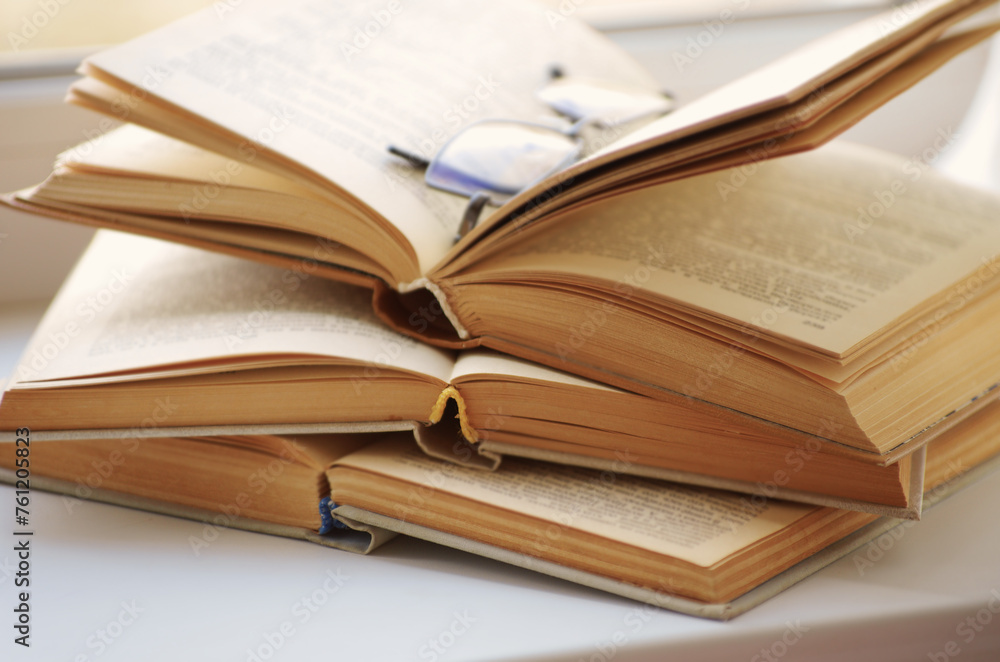 Open book on a window sill, illuminated by sunlight. Open book on a window sill, illuminated by sunlight.