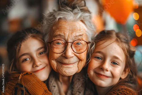 Heartwarming image of an elderly woman with glasses smiling surrounded by her loving grandchildren © Jelena