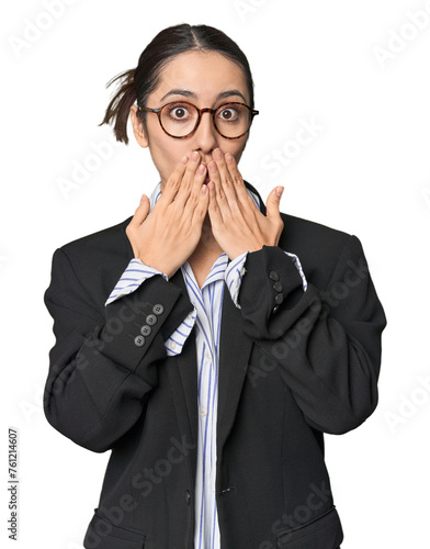 Confident young Caucasian businesswoman on studio background shocked, covering mouth with hands, anxious to discover something new.