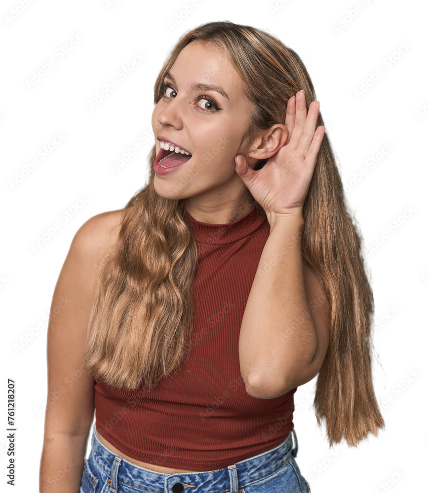 Fototapeta premium Studio portrait of a blonde Caucasian woman trying to listening a gossip.