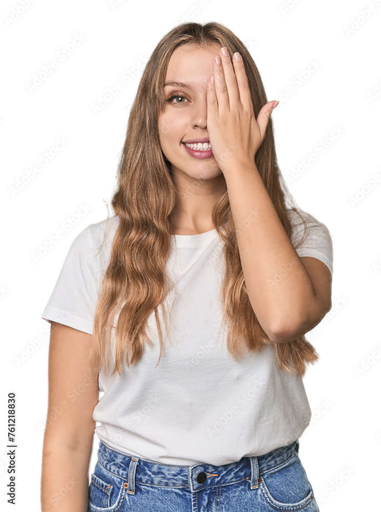 Studio portrait of a blonde Caucasian woman having fun covering half of face with palm. Studio portrait of a blonde Caucasian woman having fun covering half of face with palm.