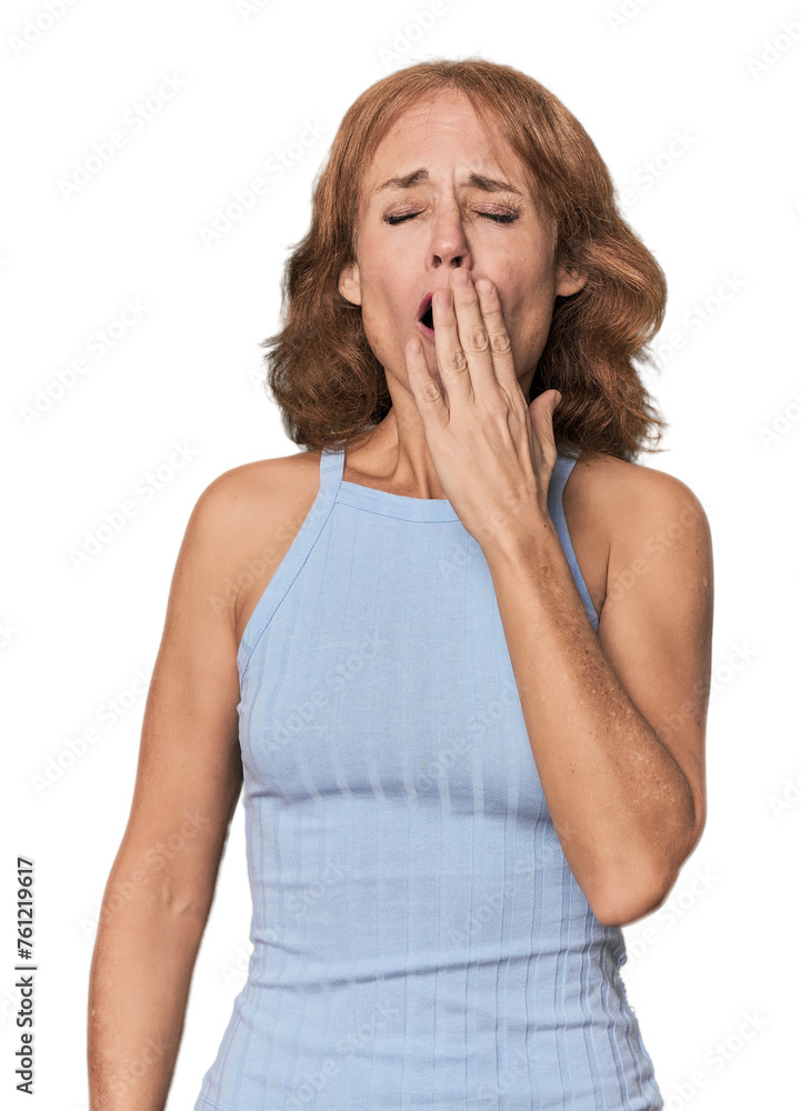 Redhead mid-aged Caucasian woman in studio yawning showing a tired gesture covering mouth with hand. Redhead mid-aged Caucasian woman in studio yawning showing a tired gesture covering mouth with hand.