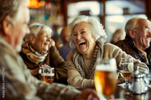 Senior people laughing with beers at pub © Jaroslav Machacek