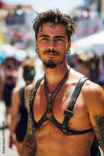 Sexy muscular latino gay man with bare abs in leather harness at the LGBT parade © alexkoral