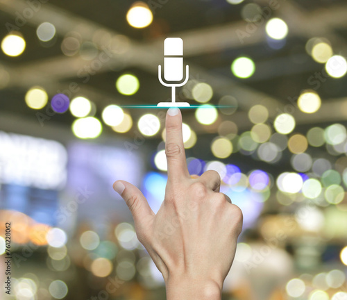 Hand pressing microphone flat icon over blur light and shadow of shopping mall, Business communication concept