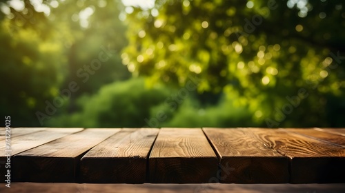 blank wooden table on the background of green trees