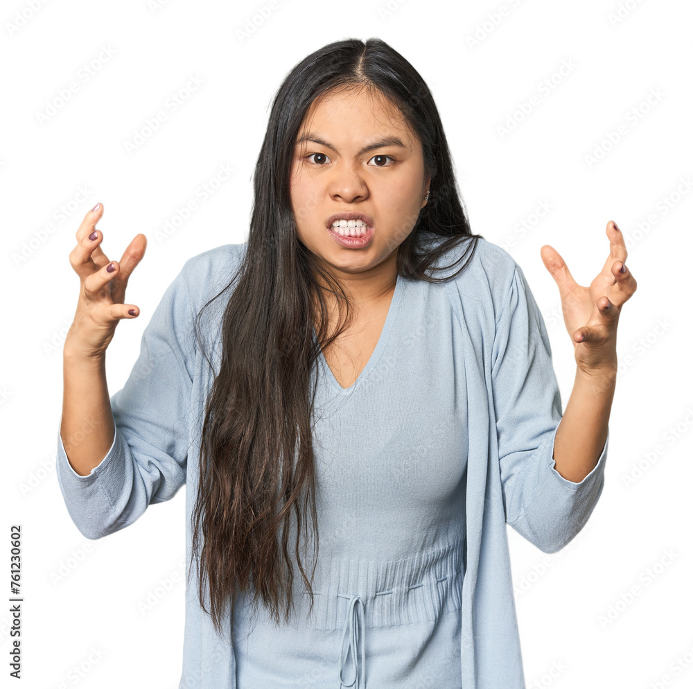 Young chinese woman isolated screaming with rage. Young chinese woman isolated screaming with rage.