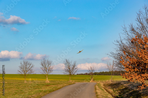 A spray plane applies chemicals to a field. Agricultural aviation.