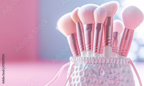 The pink and white makeup brush set with bag made of soft and elegant fabric. Soft focus, light pink background