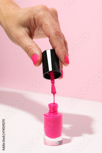 Pink nail polish with a woman's hand