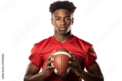 A young African American man athlete in a red jersey, confidently holding a football, isolated on a white background