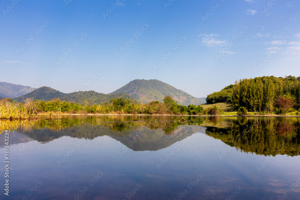 Beautiful landscape with reflection of mountain range on water at Tha Khoei reservoir in Ratchaburi, Thailand. Beautiful landscape with reflection of mountain range on water at Tha Khoei reservoir in Ratchaburi, Thailand.
