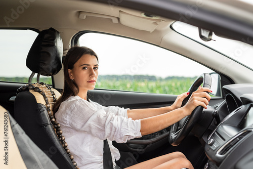 young caucasian woman hold steering wheel and driving car © RomanR