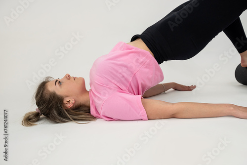 Beautiful fitness woman doing stretching exercise on a white background
