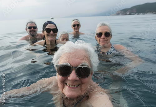Elderly people swimming in the sea, wearing sunglasses and smiling at the camera. A group of elderly men and women on vacation in the style of seaside © Kien