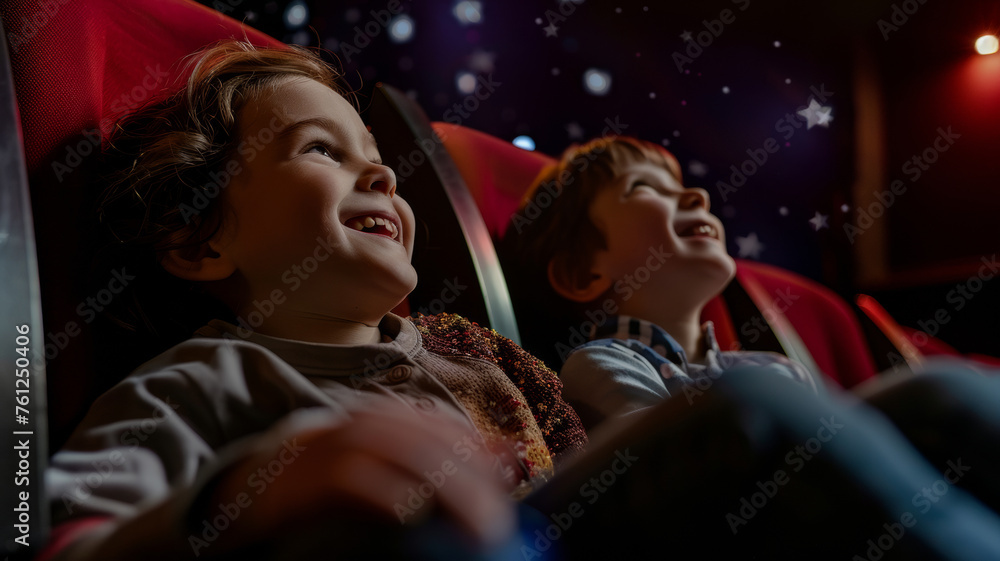 Excited children gaze up in awe at a captivating scene, their joy luminous in the dark theater.