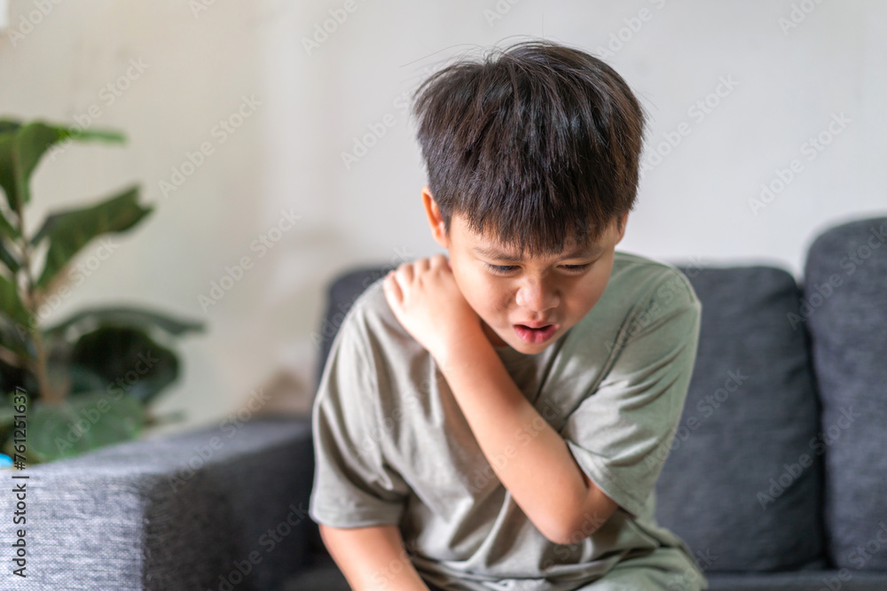 Child experiencing back pain, subtly conveying themes of health, discomfort, and the need for care in childhood, lower back with a pained expression, health and wellness, children's physical health Child experiencing back pain, subtly conveying themes of health, discomfort, and the need for care in childhood, lower back with a pained expression, health and wellness, children's physical health