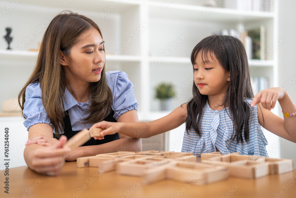 Portrait of enjoy happy love asian family mother with little asian girl smiling activity learn and skill brain training play with toy build wooden blocks board education game at home Portrait of enjoy happy love asian family mother with little asian girl smiling activity learn and skill brain training play with toy build wooden blocks board education game at home