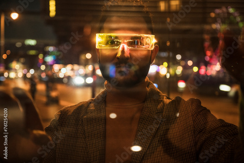 Man wearing smart glasses and seen through glass photo
