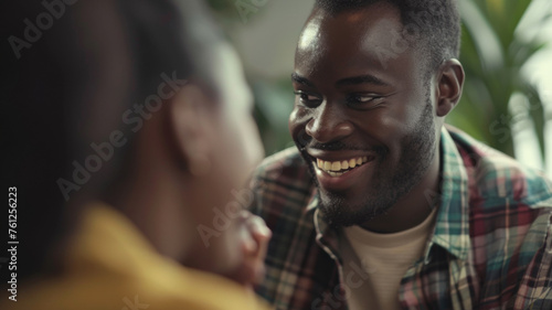 Smiling man enjoying a heartwarming conversation, his joy evident in the genuine connection he shares.