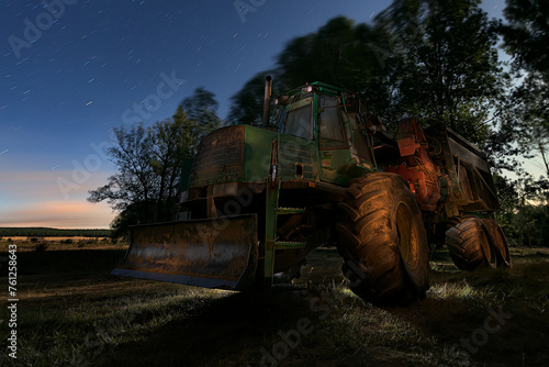 Tractor stopped in the field under a night sky full of stars waiting for dawn to start a new day in the fields of Buenavista de Valdavia, Palencia photo