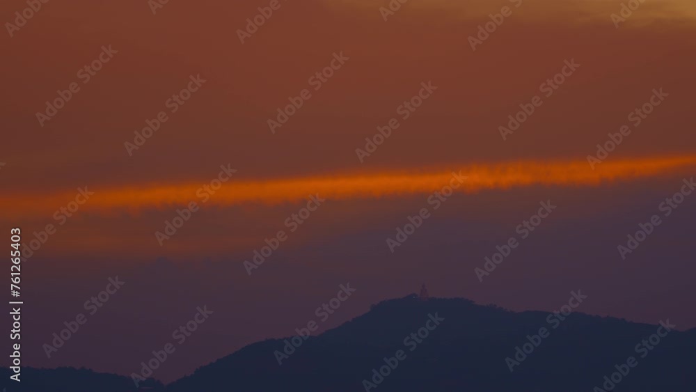 Yellow-orange streaks of clouds stretched across the sky above the Big Buddha. The Buddha sat serenely, its face turned towards the sky, its body illuminated by the sunlight. . Yellow-orange streaks of clouds stretched across the sky above the Big Buddha. The Buddha sat serenely, its face turned towards the sky, its body illuminated by the sunlight. .