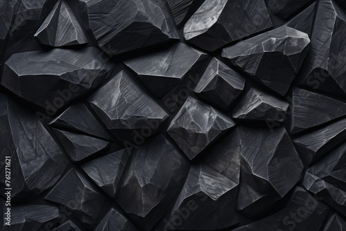 Pile of black, shiny rocks on black background