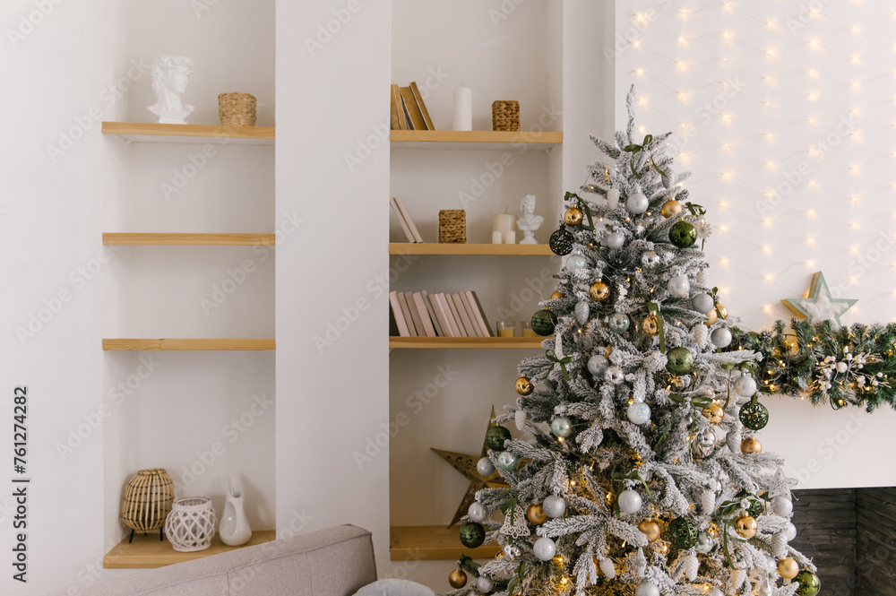 Beautiful minimalistic interior, bookcase with books and decor, Christmas tree and fireplace