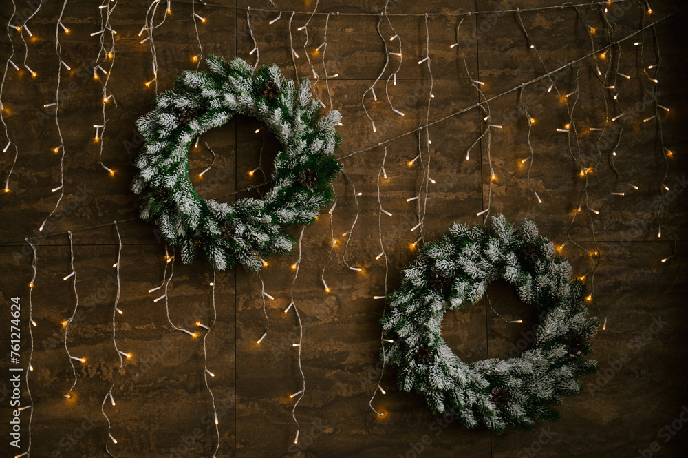 New Year wreaths with lights on a wooden wall background, New Year decor