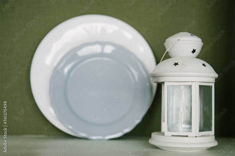 Beautiful interior of the room with a candlestick and plates on the shelf