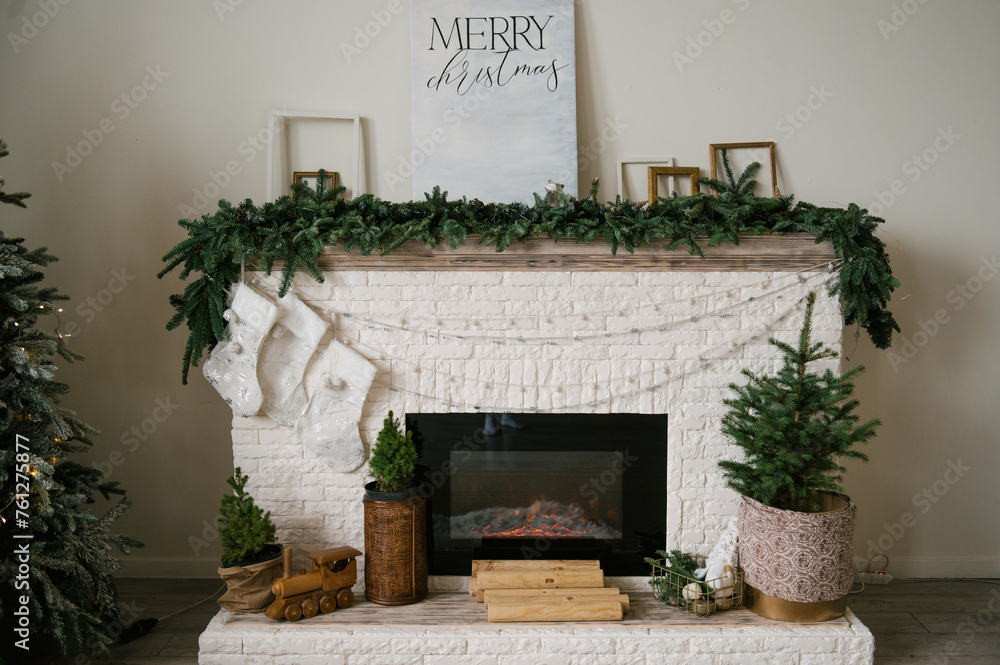 Beautiful stylish modern interior with fireplace decorated for the new year