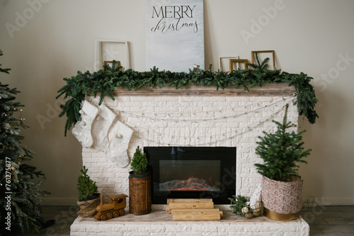 Obraz na płótnie Beautiful stylish modern interior with fireplace decorated for the new year w salonie