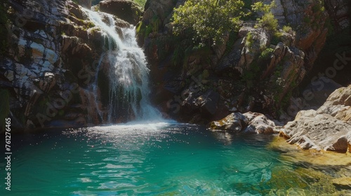 A majestic waterfall cascading down a rocky cliff into a crystal-clear pool below