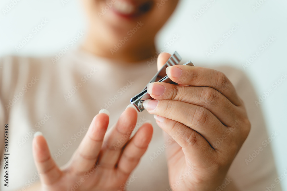 A woman is holding a pair of nail clippers A woman is holding a pair of nail clippers