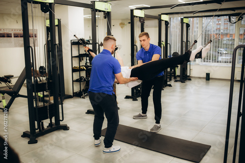 a rehabilitator works with a woman in a rehabilitation center © Roman