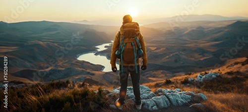 Hiker witnessing the golden sunrise over a serene mountain lake, embodying the spirit of adventure, outdoor exploration, hiking, and travel